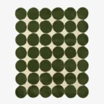 Top down view of the Still Meadow rug featuring a bold geometric pattern of large deep green circles arranged in a grid on a cream wool background.