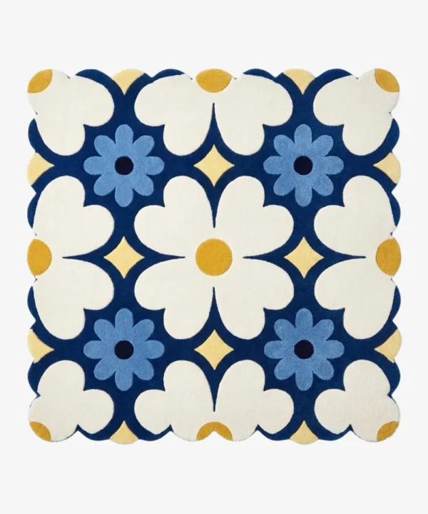 Top down view of the Sun Dot Posy square rug featuring a retro geometric floral pattern with cream and blue flowers on a navy background with scalloped edges.