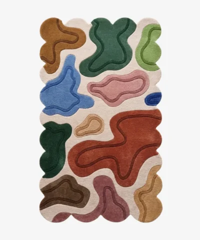 Top down view of the Terra Pebble rug featuring a cream background with distinct organic abstract shapes in terracotta blue green and pink.