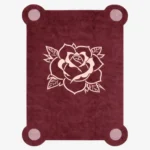 Top down view of the Velvet Bloom rug featuring a deep maroon wool background with a central traditional tattoo-style rose illustration in light pink and cream, framed by decorative pink corner accents.