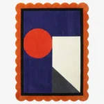 Top down view of the Amber Solis rug featuring a radiant sun-inspired geometric design in warm amber and golden yellow wool, finished with custom scalloped edges.