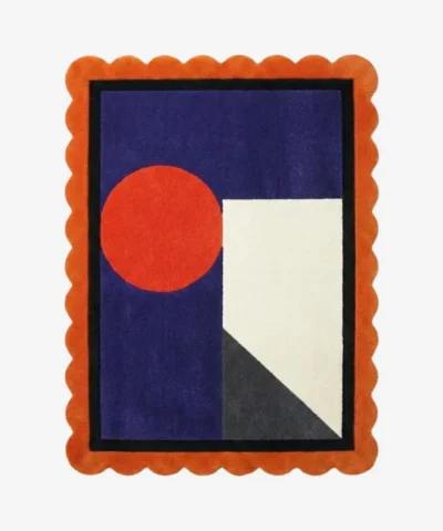 Top down view of the Amber Solis rug featuring a radiant sun-inspired geometric design in warm amber and golden yellow wool, finished with custom scalloped edges.