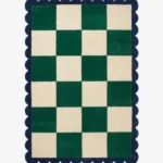 Top down view of the Arcet Offset rug featuring a playful checkered pattern with shifted blocks and curved "arc" details in high-quality wool, finished with custom scalloped edges.