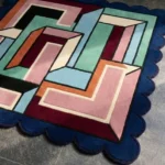 Close-up perspective of the Arched Junction rug, highlighting the plush hand-tufted wool texture and the 3D carved depth of the colorful interlocking tube design.