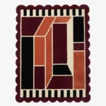 Top down view of the Burnt Frame rug featuring a neutral wool center framed by a rich burnt orange and brown border, finished with custom scalloped edges.