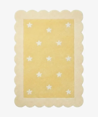 Top down view of the Buttercream Bloom rug featuring a soft yellow rectangular center with a white star pattern, completely surrounded by a decorative cream scalloped border.