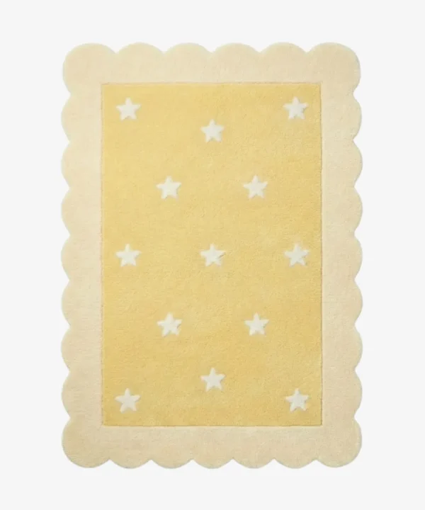 Top down view of the Buttercream Bloom rug featuring a soft yellow rectangular center with a white star pattern, completely surrounded by a decorative cream scalloped border.