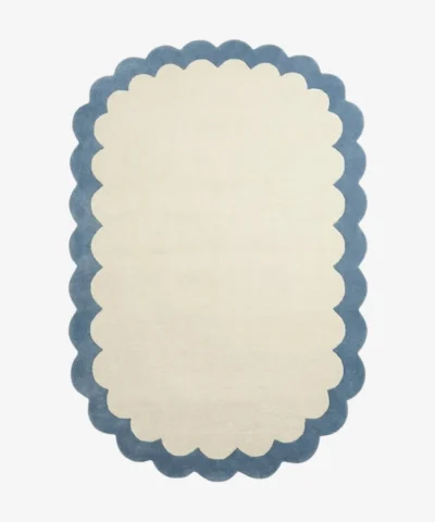 Top down view of the Cloud Marina rug featuring a soft cream center framed by a calming light blue scalloped border.