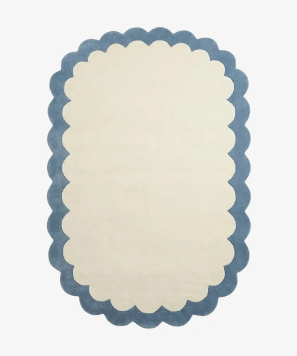 Top down view of the Cloud Marina rug featuring a soft cream center framed by a calming light blue scalloped border.