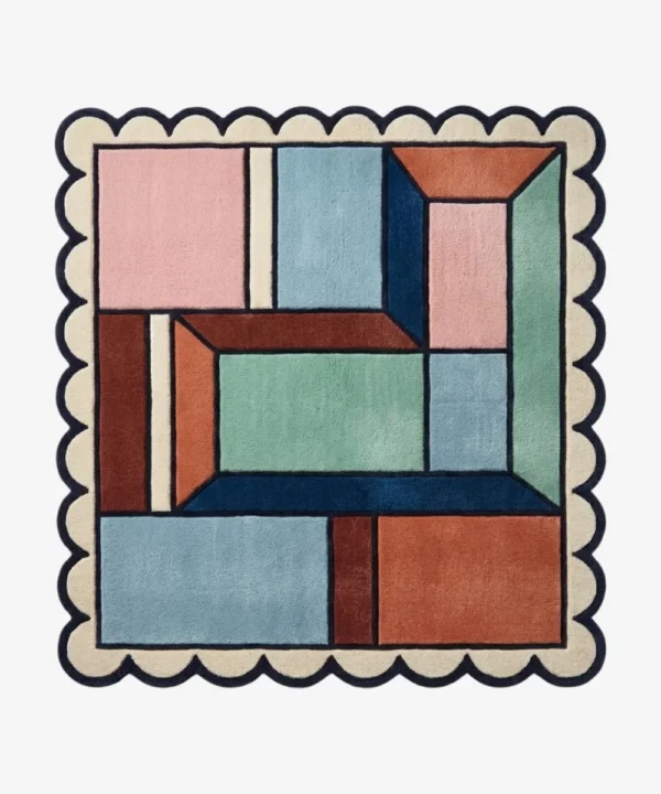 Top down view of the Dusty Dune Square rug featuring a geometric color block design in dusty blue, terracotta, and mint green, framed by a dark blue scalloped border.