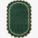 Top down view of the Emerald Veranda rug featuring a solid emerald green background with a decorative cream border containing wavy lines and polka dots.