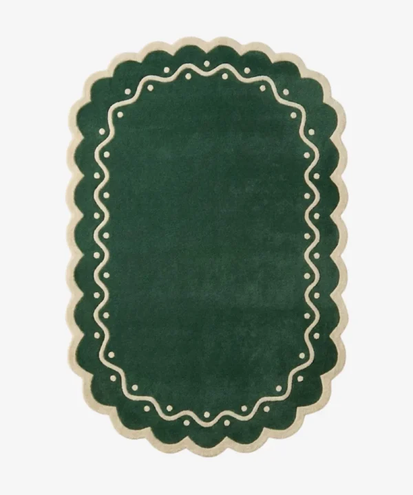 Top down view of the Emerald Veranda rug featuring a solid emerald green background with a decorative cream border containing wavy lines and polka dots.