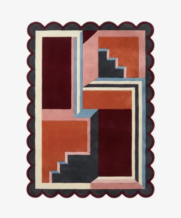 Top down view of the Inverse Staircase rug featuring a bold geometric design with an interlocking step pattern creating an optical depth effect, finished with custom scalloped edges.