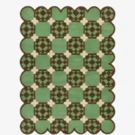 Top-down view of the Meadow Tiling rug against a white background, featuring a repeating geometric patchwork pattern of light green squares with inner brown checkered details, connected by cream cross motifs, framed by a continuous dark brown scalloped border.