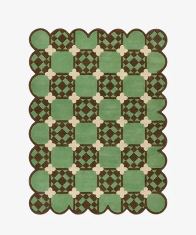Top-down view of the Meadow Tiling rug against a white background, featuring a repeating geometric patchwork pattern of light green squares with inner brown checkered details, connected by cream cross motifs, framed by a continuous dark brown scalloped border.