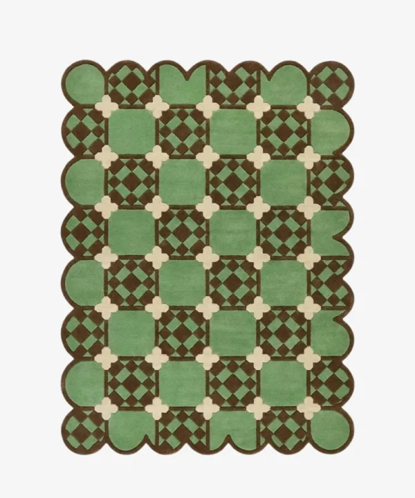 Top-down view of the Meadow Tiling rug against a white background, featuring a repeating geometric patchwork pattern of light green squares with inner brown checkered details, connected by cream cross motifs, framed by a continuous dark brown scalloped border.