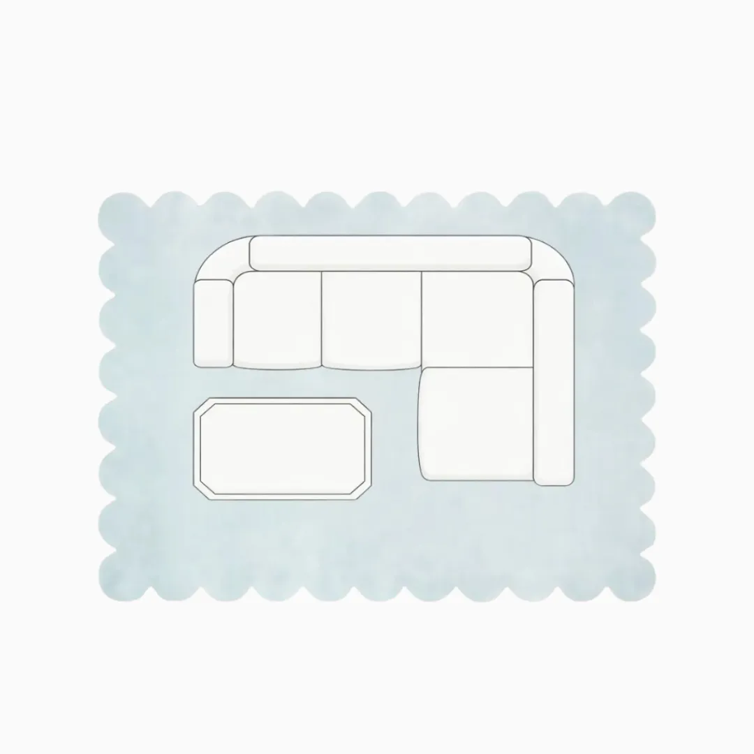Top down diagram of a medium living room layout featuring an 8x10 scalloped rug, showing a sectional sofa and coffee table placed with all front legs on the rug to anchor the space.