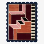 Top down view of the Muted Garnet rug featuring a sophisticated, dusty red wool background with a soft, plush texture and custom scalloped edges.