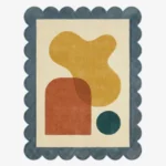 Top down view of the Ochre Loom rug featuring a warm mustard yellow wool background with a textured, woven-inspired pattern, finished with custom scalloped edges.