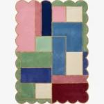 Top down view of the Piatched Poise rug featuring a dynamic, multi-colored geometric block design that mixes pastel shades with deep jewel tones, completely surrounded by a decorative scalloped border.