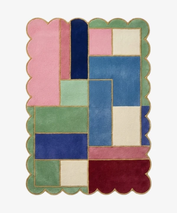 Top down view of the Piatched Poise rug featuring a dynamic, multi-colored geometric block design that mixes pastel shades with deep jewel tones, completely surrounded by a decorative scalloped border.
