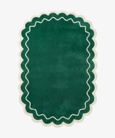 Top down view of the Pine Estate rug featuring a solid pine green wool background with a decorative cream wavy line and scalloped border.