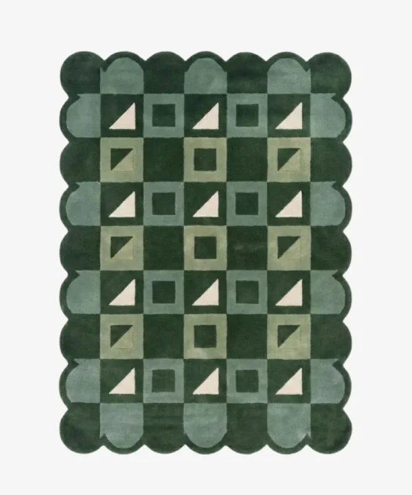 Top-down view of the Pine Patchwork rug against a white background, featuring a repeating geometric patchwork pattern of squares and triangles in shades of dark green, soft green, and cream, framed by a continuous dark green scalloped border.