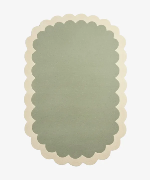 Top down view of the Pistachio Whale rug featuring a soothing ombre gradient design transitioning from sage green to soft cream, framed by a scalloped border.