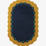 Top down view of the Royal Indigo rug featuring a deep navy blue center framed by a mustard gold scalloped border with delicate teal floral accents.
