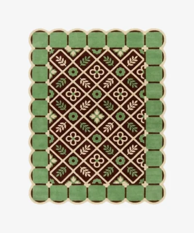 Top-down view of the Scroll Halo rug against a white background, featuring a dark brown center with a geometric diamond lattice pattern enclosing alternating cream floral motifs and light green leaf sprigs, surrounded by a light green square tile border and framed by a continuous cream scalloped edge.