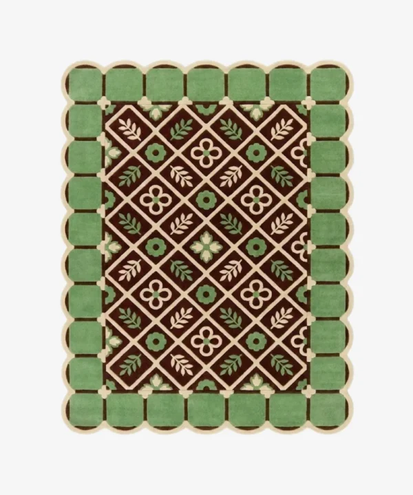 Top-down view of the Scroll Halo rug against a white background, featuring a dark brown center with a geometric diamond lattice pattern enclosing alternating cream floral motifs and light green leaf sprigs, surrounded by a light green square tile border and framed by a continuous cream scalloped edge.
