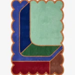 Top down view of the Soft Lagoon rug featuring a calming teal green wool background with a delicate geometric grid pattern and custom scalloped edges.