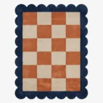 Top down view of the Solace Tide rug featuring a soothing checkered pattern in shades of soft coastal blue and cream wool, finished with custom scalloped edges.