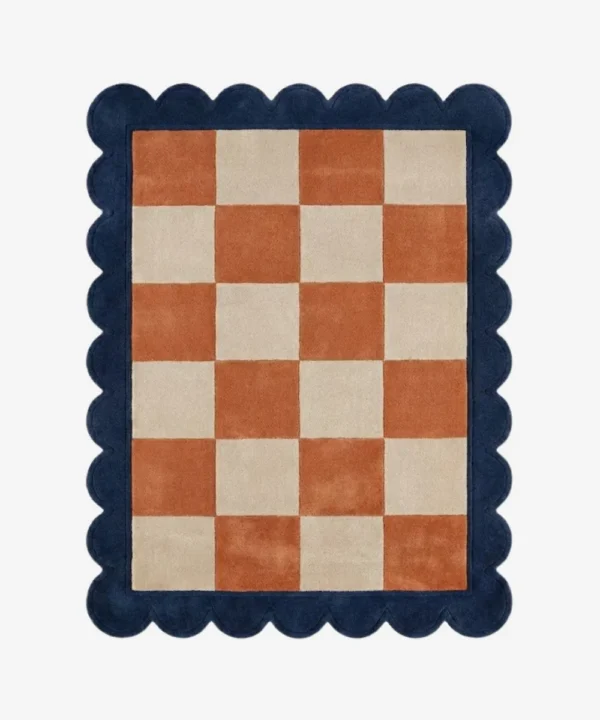 Top down view of the Solace Tide rug featuring a soothing checkered pattern in shades of soft coastal blue and cream wool, finished with custom scalloped edges.