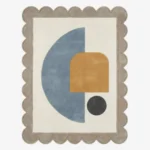 Top down view of the Still Shore rug featuring a calming abstract geometric design with a large blue semi-circle and ochre arch accent on a cream wool background, finished with custom scalloped edges.