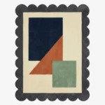 Top down view of the Stone Leaf rug featuring a calming geometric design with earthy stone grey and sage green accents on a plush wool background, finished with custom scalloped edges.