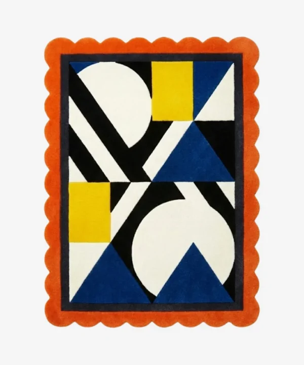 Top down view of the Sunpatch Mosaic rug featuring a bold geometric pattern with blue triangles, yellow blocks, and black and white accents, framed by a vibrant orange scalloped edge.