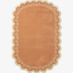 Top down view of the Terra Manor rug featuring a warm rust terracotta background with a decorative cream border containing a wavy line and polka dots.