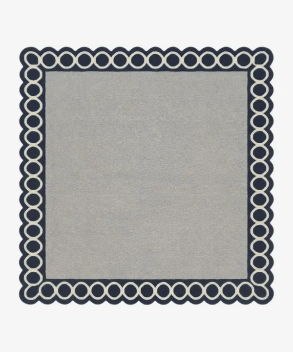 Top-down view of the Chain Frame square rug featuring a solid light grey center field framed by a bold navy blue border with interlocking white circular chain links.