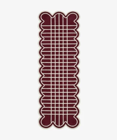 Top down view of the hand-tufted Marvion Trace Runner Rug featuring a deep burgundy background, a cream geometric grid pattern, and scalloped edges.
