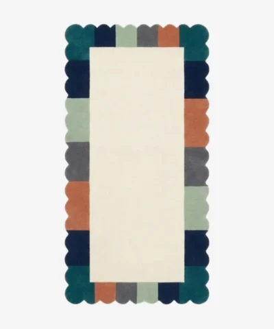 Top-down view of the Palette Parade runner rug featuring a clean ivory center field framed by a playful scalloped border with color-blocked segments in forest green, navy, mint, charcoal, and rust orange.
