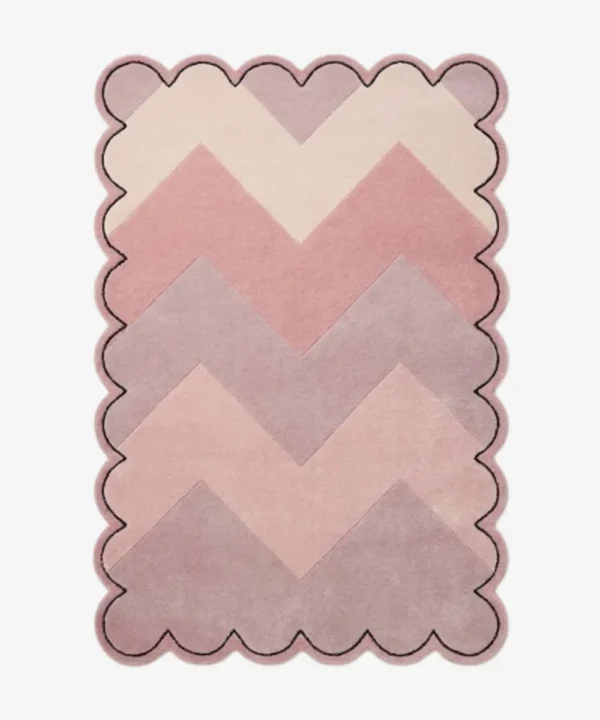 Top-down view of the Rose Chevron rug featuring a gradient zigzag pattern in shades of cream, soft blush, rose, and mauve, framed by a continuous scalloped border with a thin black outline.