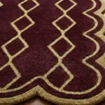 Angled close-up of the Solyvr Axis Runner Rug showing the thick hand-tufted dense wool cut pile, gold diamond lines, and scalloped edge binding.