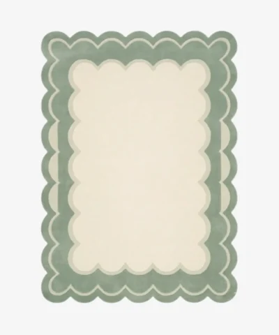 Top-down view of the rectangular Sylvena Crest rug, featuring a large solid cream center framed by a delicate inner wavy contour line and a thick, soft sage green scalloped outer border.