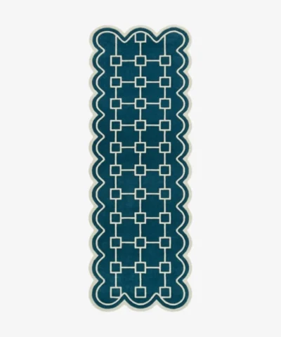 Top down view of the hand-tufted Terenza Coil Runner Rug featuring a rich teal background, a cream geometric square chain pattern, and distinctive scalloped edges.