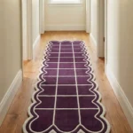 Perspective view of the Velquor Vane scalloped runner rug styled in a bright, neutral hallway with light hardwood floors, showcasing its striking purple and cream grid design extending down the corridor.