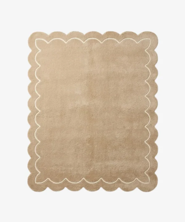 Top-down view of the rectangular Velune Nest rug, featuring a solid warm tan background bordered by a scalloped edge and a delicate, continuous cream inner line mimicking the wavy silhouette.