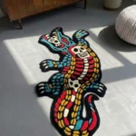 Close-up angled detail of the Alligator Skeleton rug's tail, emphasizing the thick hand-tufted New Zealand wool and the distinct carved separation between the curving white tail bones and black base.