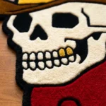 Close-up macro detail of the Cowboy Skull rug, highlighting the totally dense texture of the 100% New Zealand wool and the deep carving of the skull's teeth and hollow eye sockets.