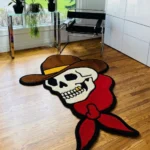 Perspective view of the die-cut Cowboy Skull traditional tattoo rug styled on a warm hardwood floor in a cozy den, positioned near a classic leather armchair.